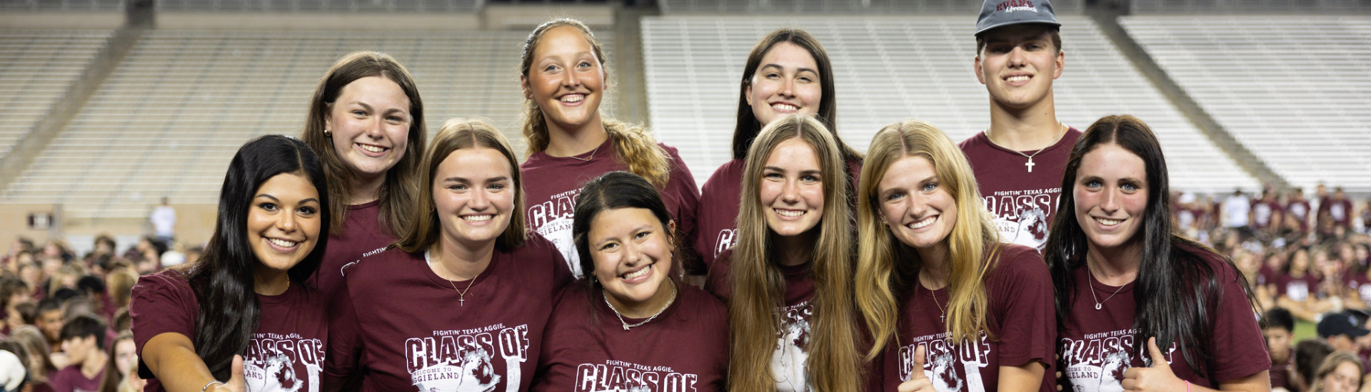 Students posing for a photo at the Class of 2028 Class Photo on Kyle Field.